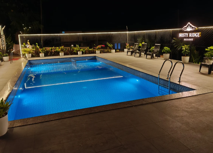 Misty Ridge Resort illuminated swimming pool at night in Vythiri Wayanad