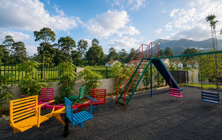 Montana Wild outdoor children play area with swings and mountain views in Wayanad